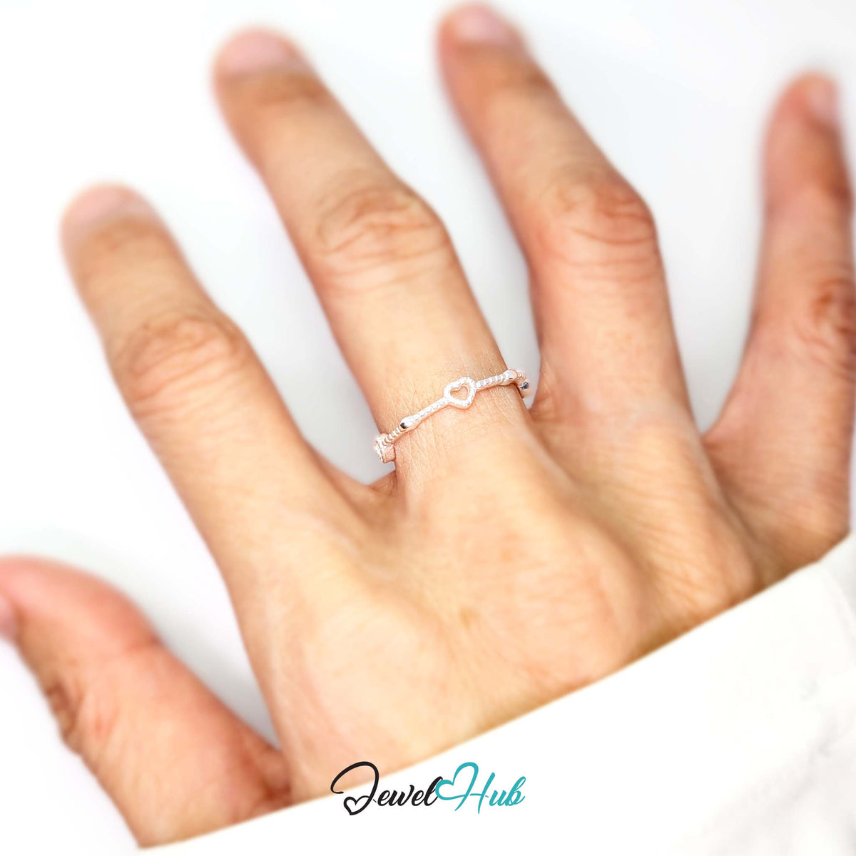 Three hearts ring worn on a hand, showing the fit of the adjustable M-O band - JewelHub