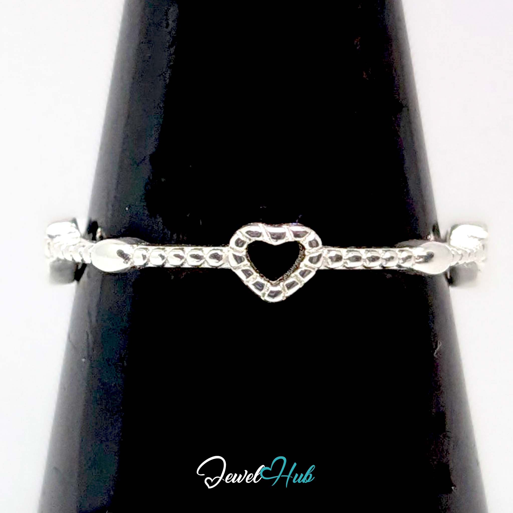 Three hearts ring against a black cone, showing the beaded rims of the hearts - JewelHub