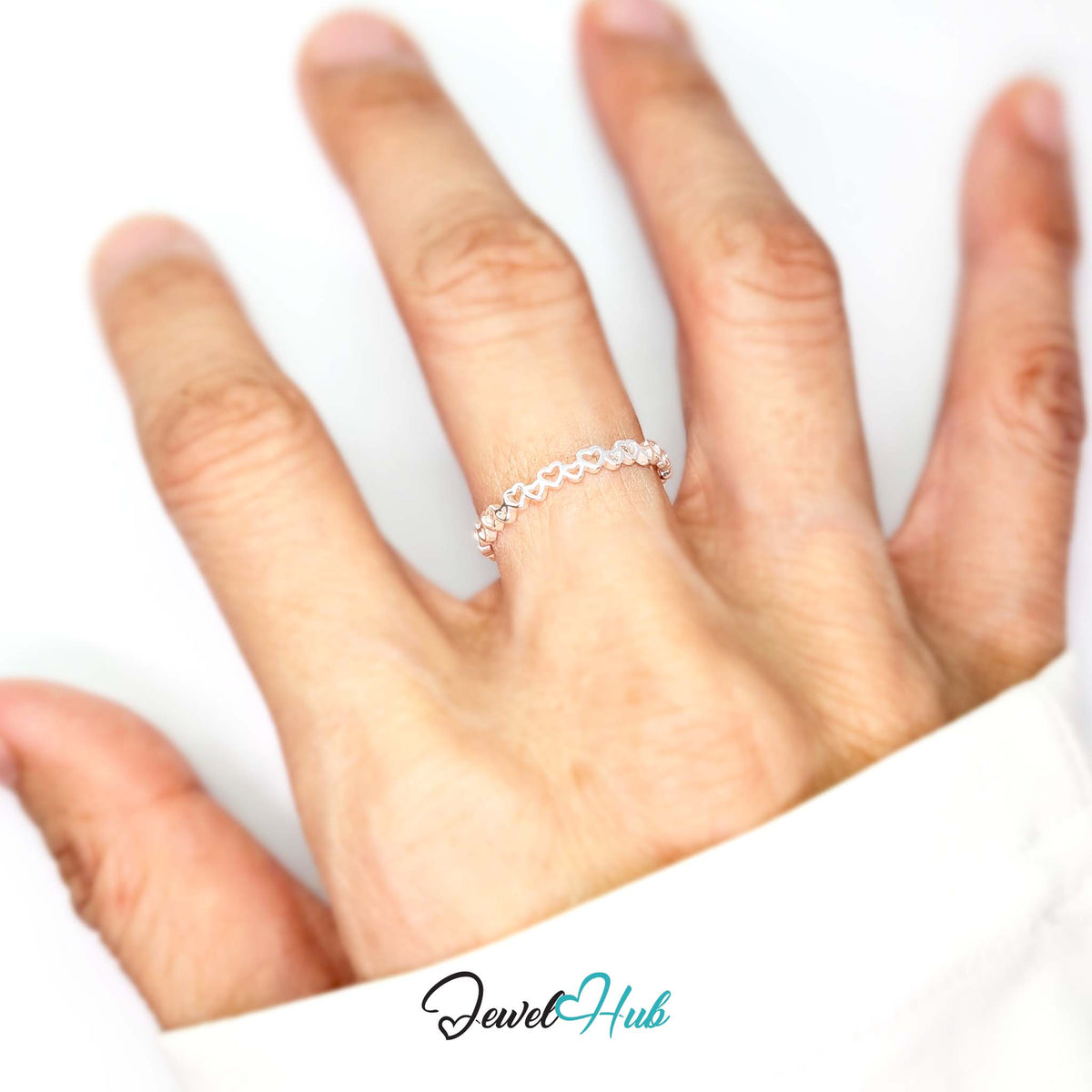 Linked hearts band worn on a hand, showing the fit of the larger N-P band - JewelHub