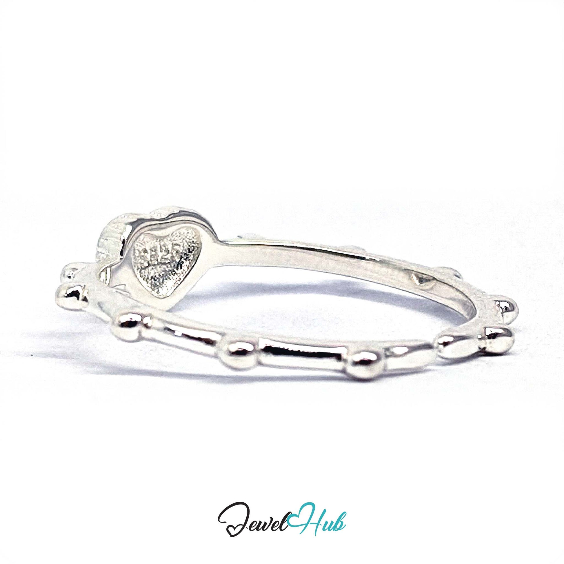 Cross heart ring rotated to show the beaded links running round the band - JewelHub