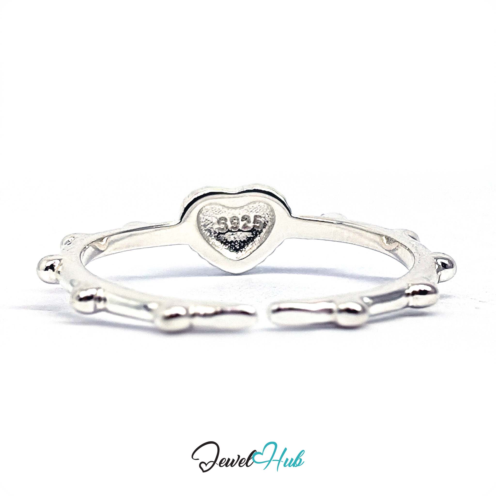 Cross heart ring from above, showing the beaded rim framing the heart - JewelHub