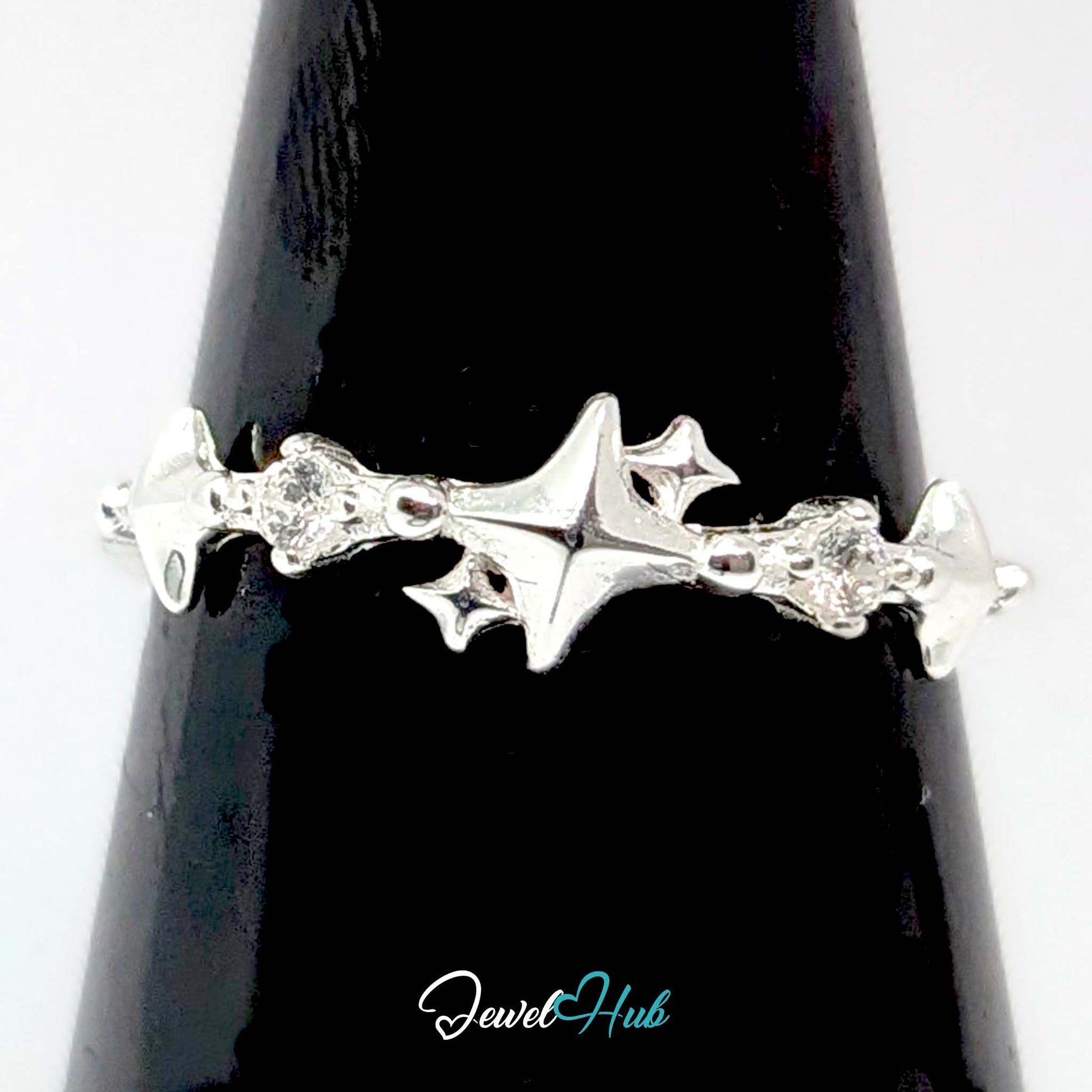 Sparkle ring against a black cone, the stars and crystals catching light - JewelHub