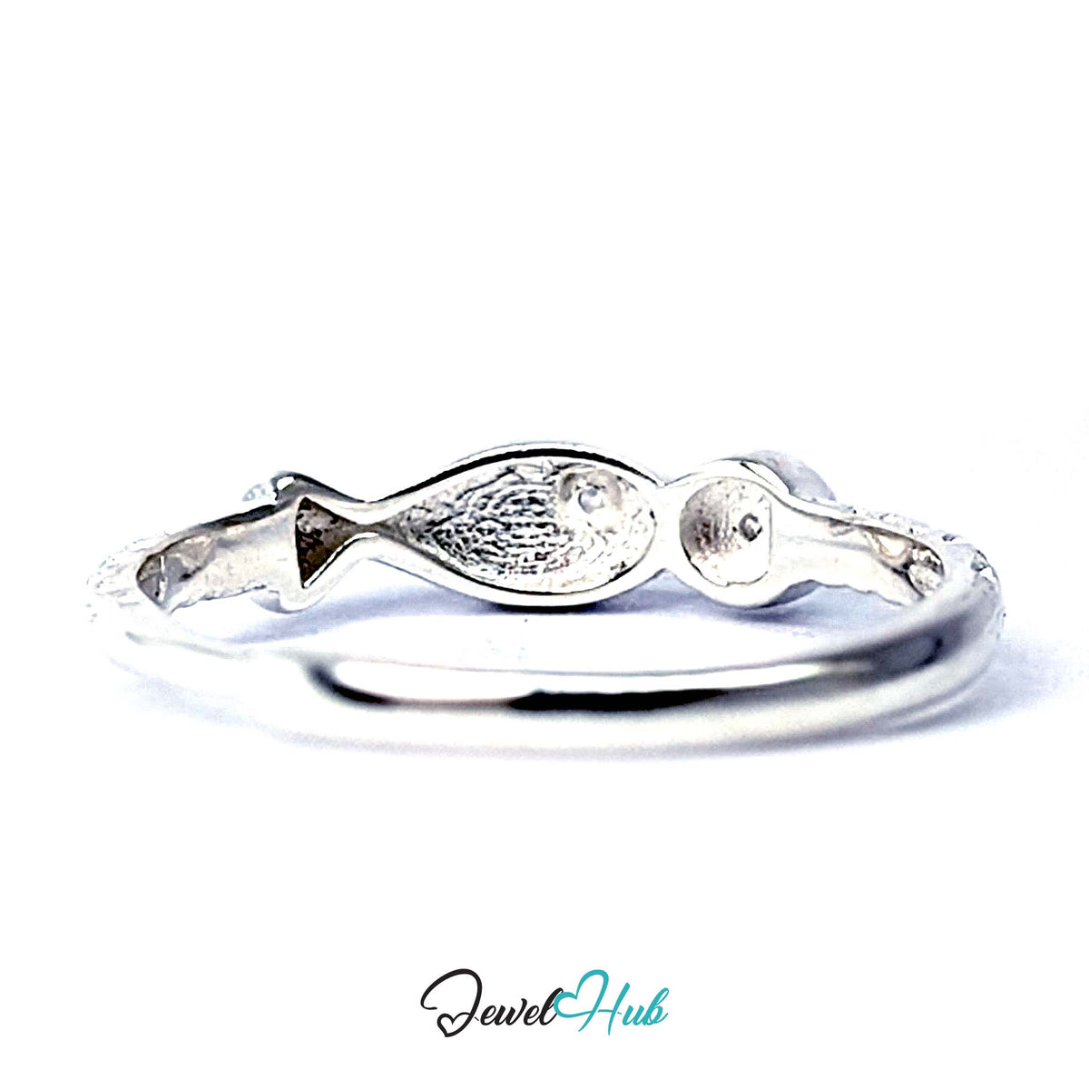 Angled view of the fish tail and coin motif meeting on the band - JewelHub