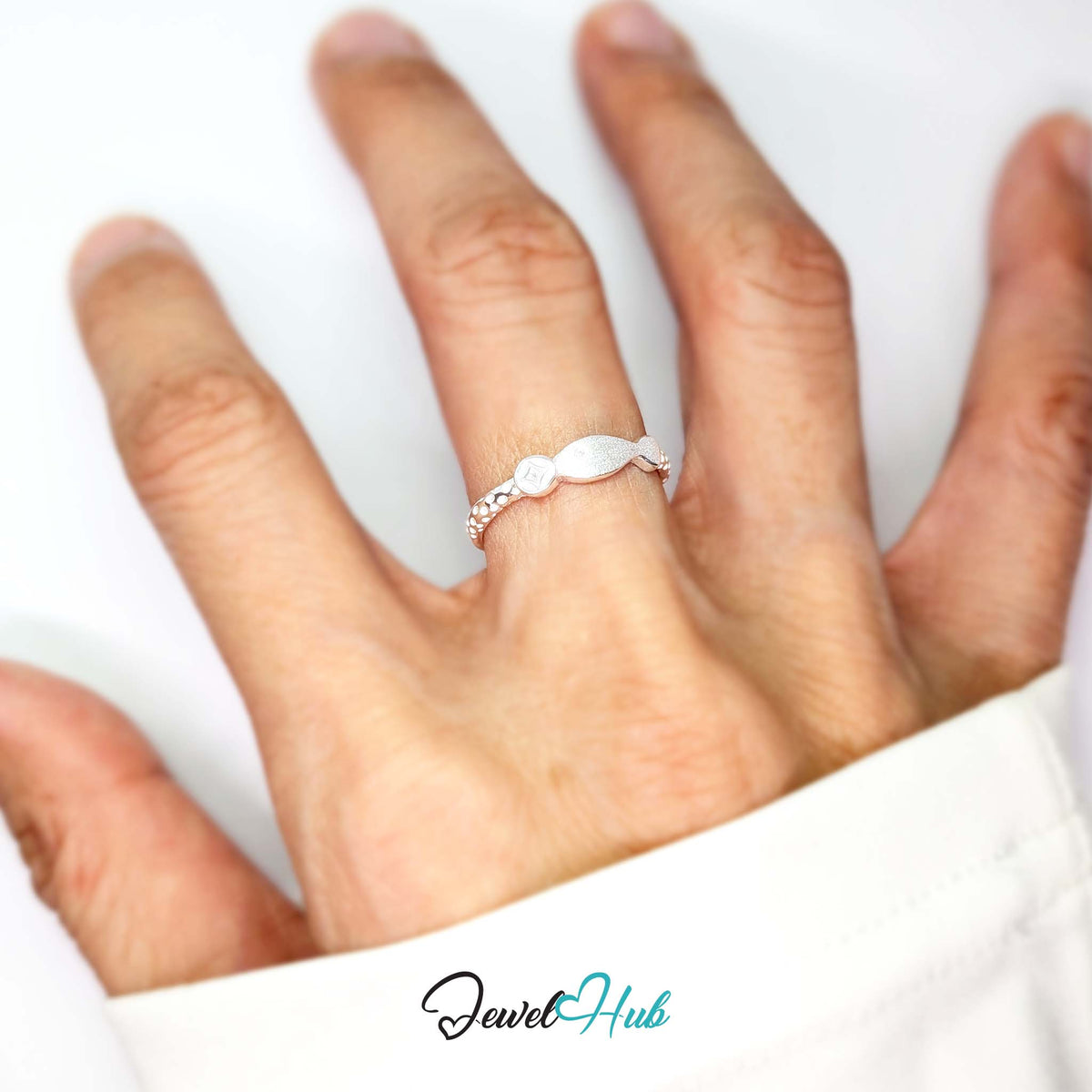Coin and fish ring worn on a hand, showing the adjustable M-O fit - JewelHub