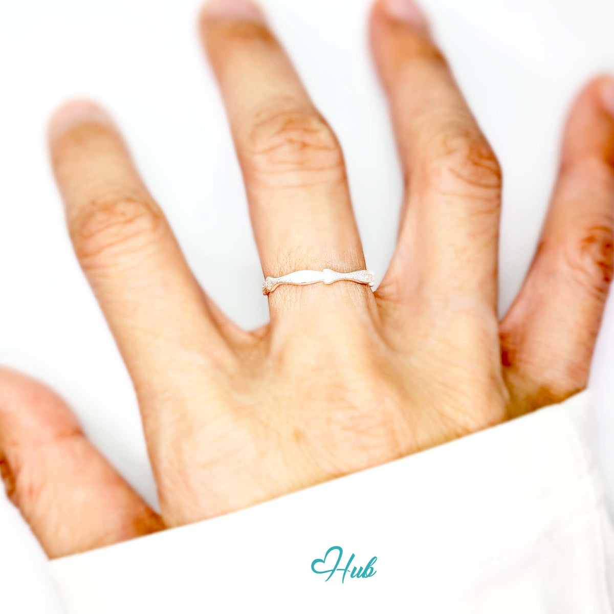 Five fish ring worn on a hand, showing the adjustable M-O fit - JewelHub