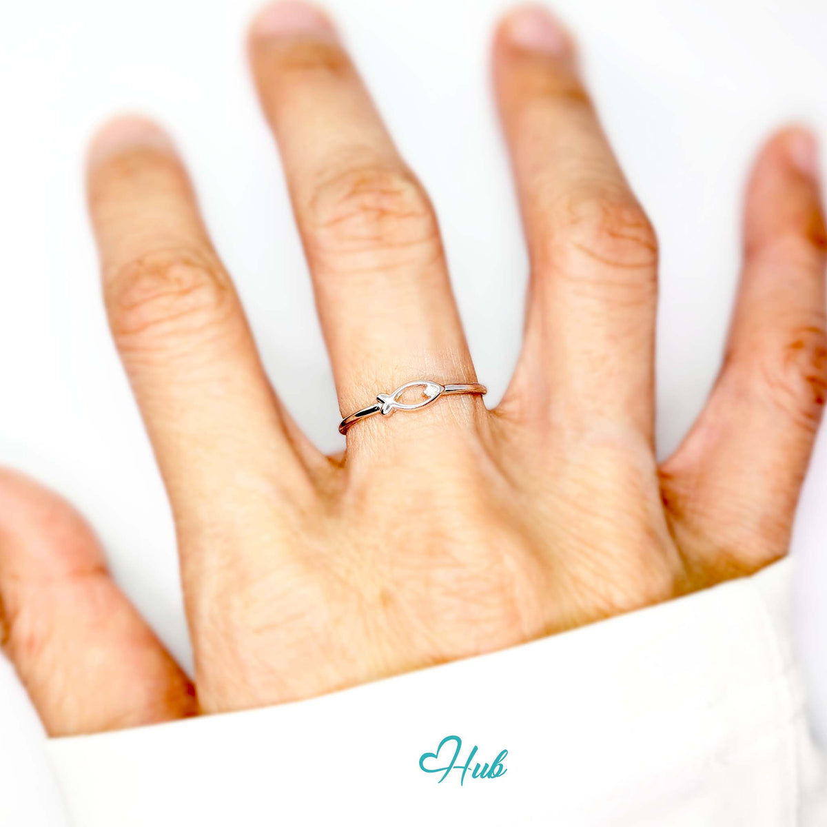 Fish outline ring worn on a hand, showing the adjustable M-O fit - JewelHub