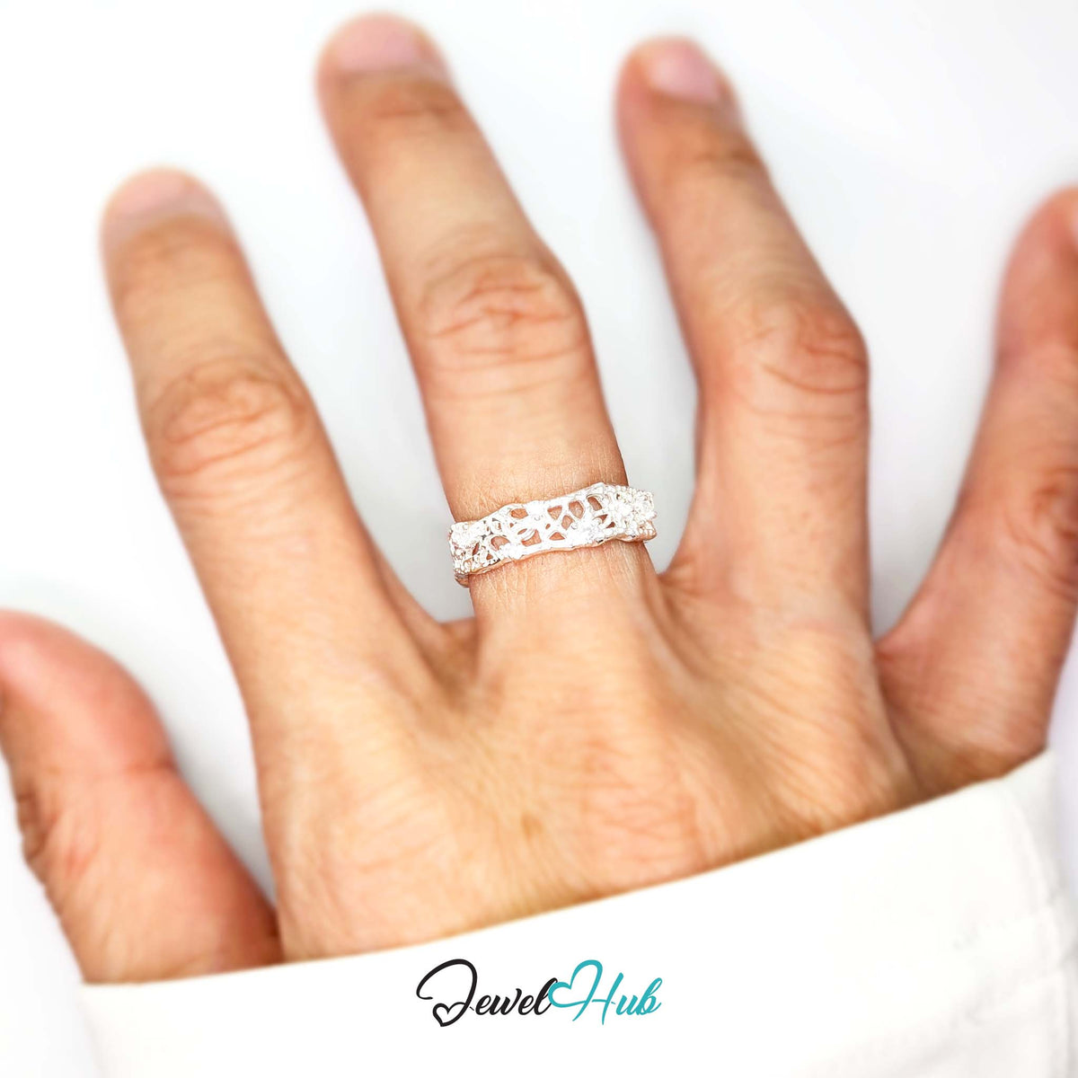 Openwork ring worn on a hand, showing the width of the 5.4mm band - JewelHub