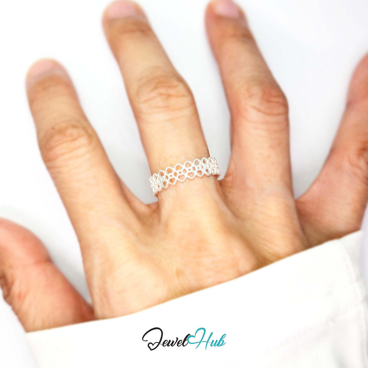 Crown lace ring worn on a hand, showing the adjustable M-O fit - JewelHub