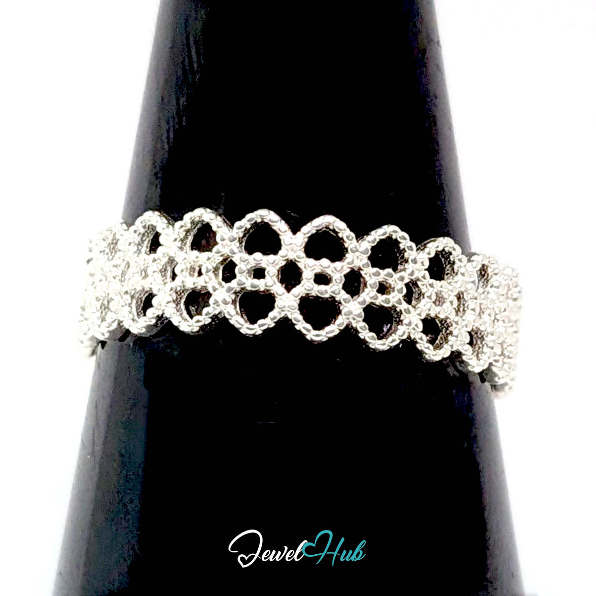 Crown lace ring on a black cone display, showing the pierced lacework - JewelHub