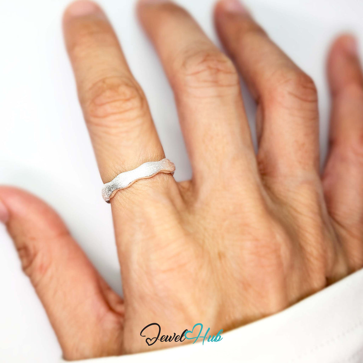 Wave edge ring worn on a hand, showing the 4mm band on the finger - JewelHub
