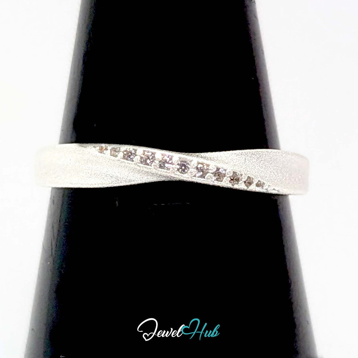 Mobius twist ring on a black cone display, showing the line of zirconia - JewelHub