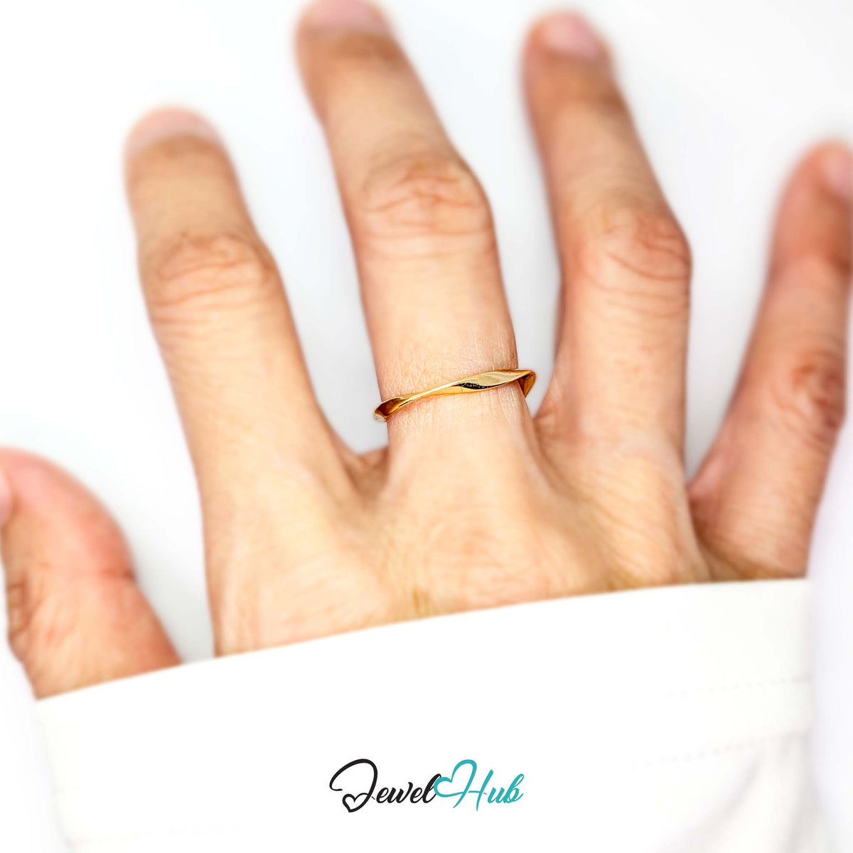 Gold-plated twist ring worn on a hand, showing the adjustable M-O fit - JewelHub