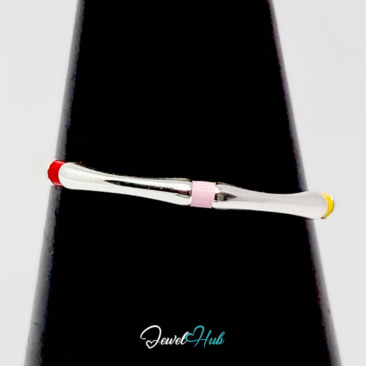 Enamel ring on a black cone display, showing red, pink and yellow collars - JewelHub