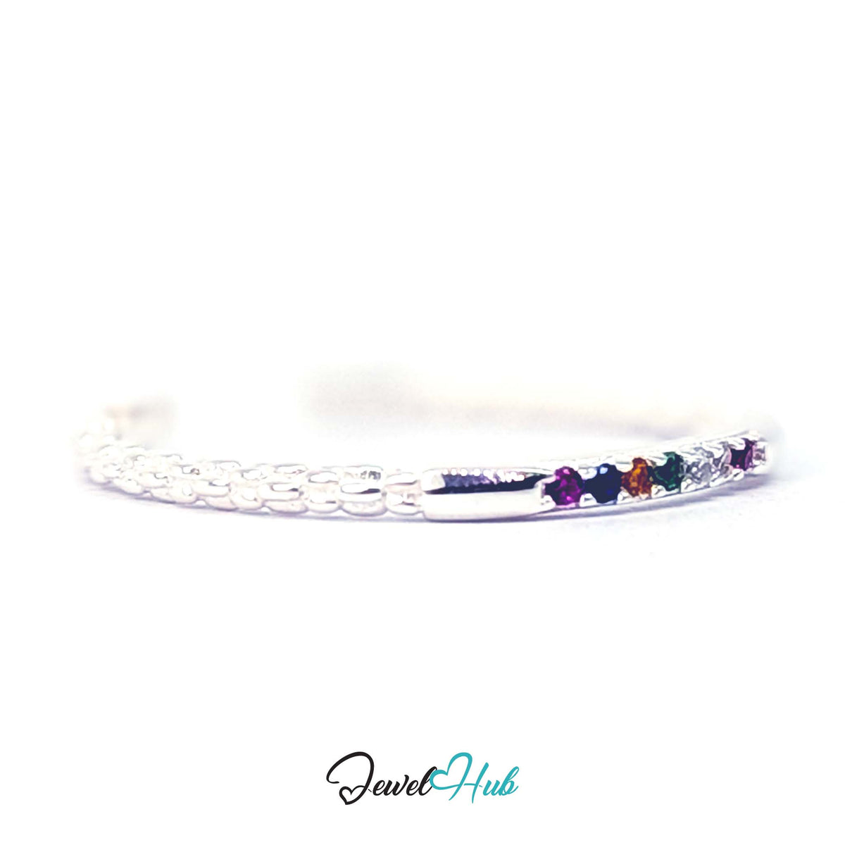 Close view of the magenta, navy, orange and green zirconia set in a line - JewelHub