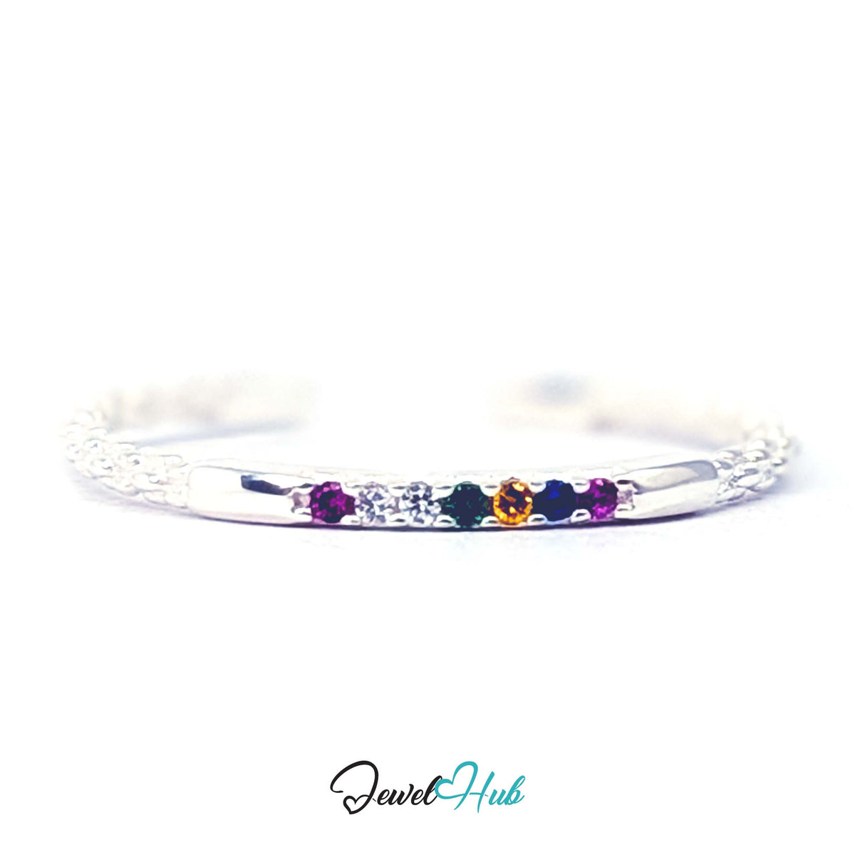Rainbow ring at an angle, showing all six coloured stones on the front bar - JewelHub