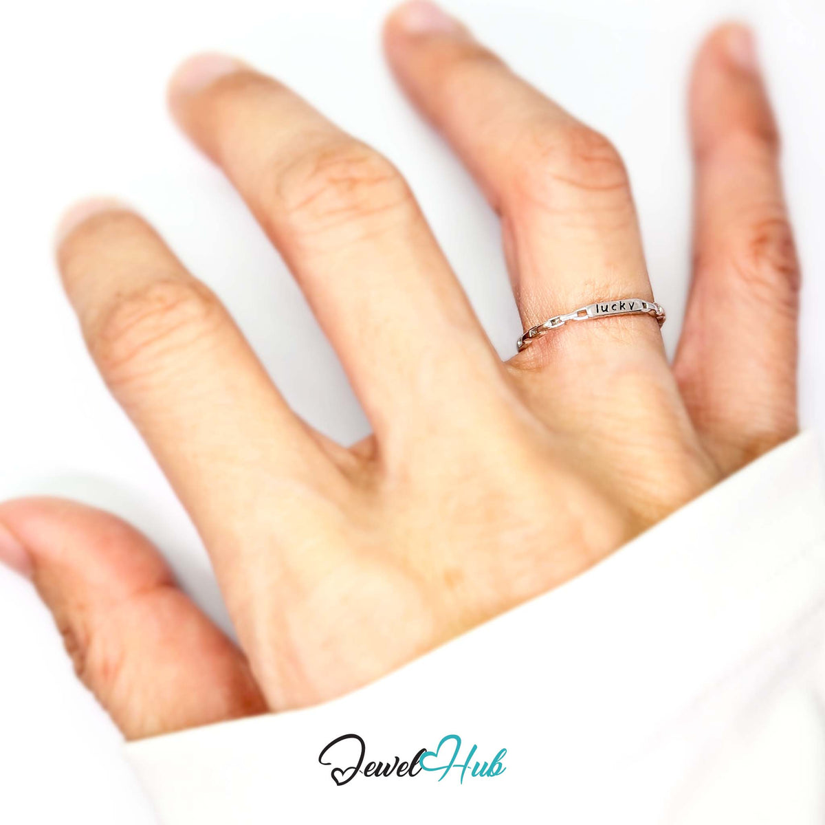 Lucky plate ring worn on a hand, showing the adjustable M-O fit - JewelHub