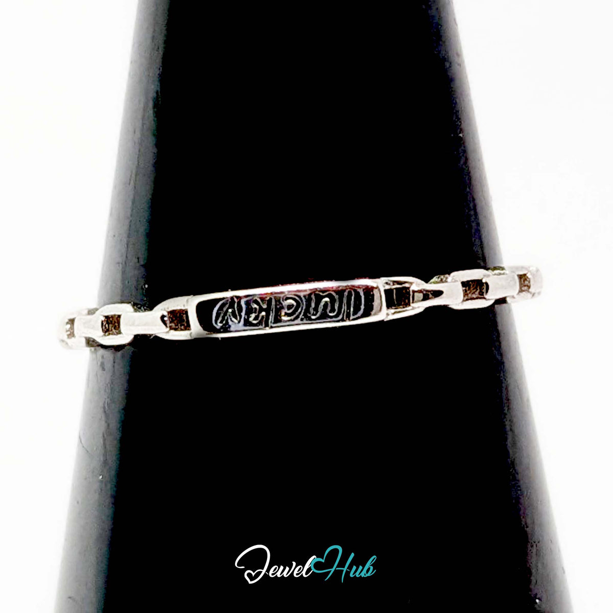 Lucky ring on a black cone, the engraved plate reading from the wearer's side - JewelHub