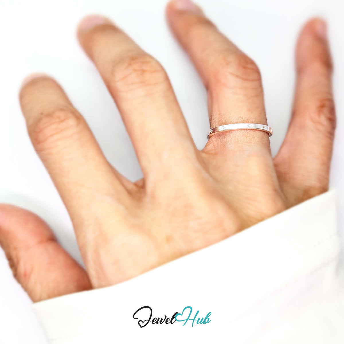 Starburst ring worn on a hand, showing the slim L-N band - JewelHub