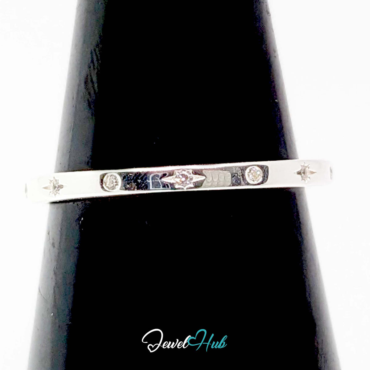 Starburst ring on a black cone display, showing the flush-set stones - JewelHub