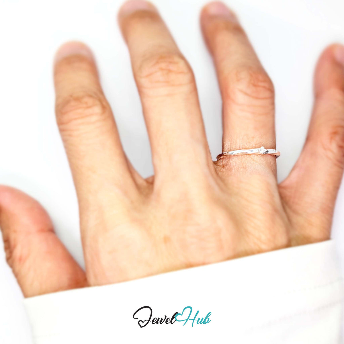 Twist ring worn on a hand, showing the small I-K fit - JewelHub