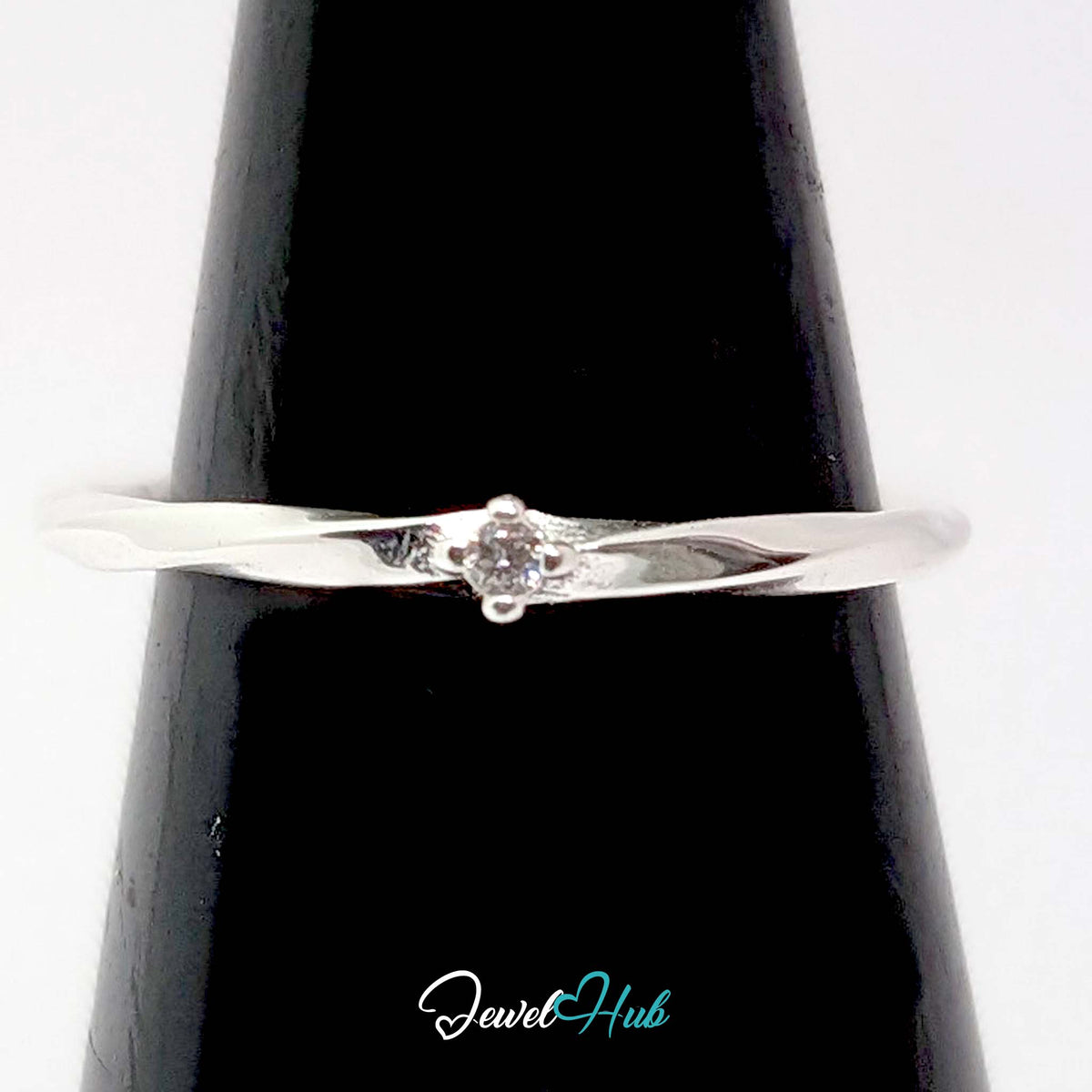 Twist ring on a black cone display, showing the claw-set stone - JewelHub