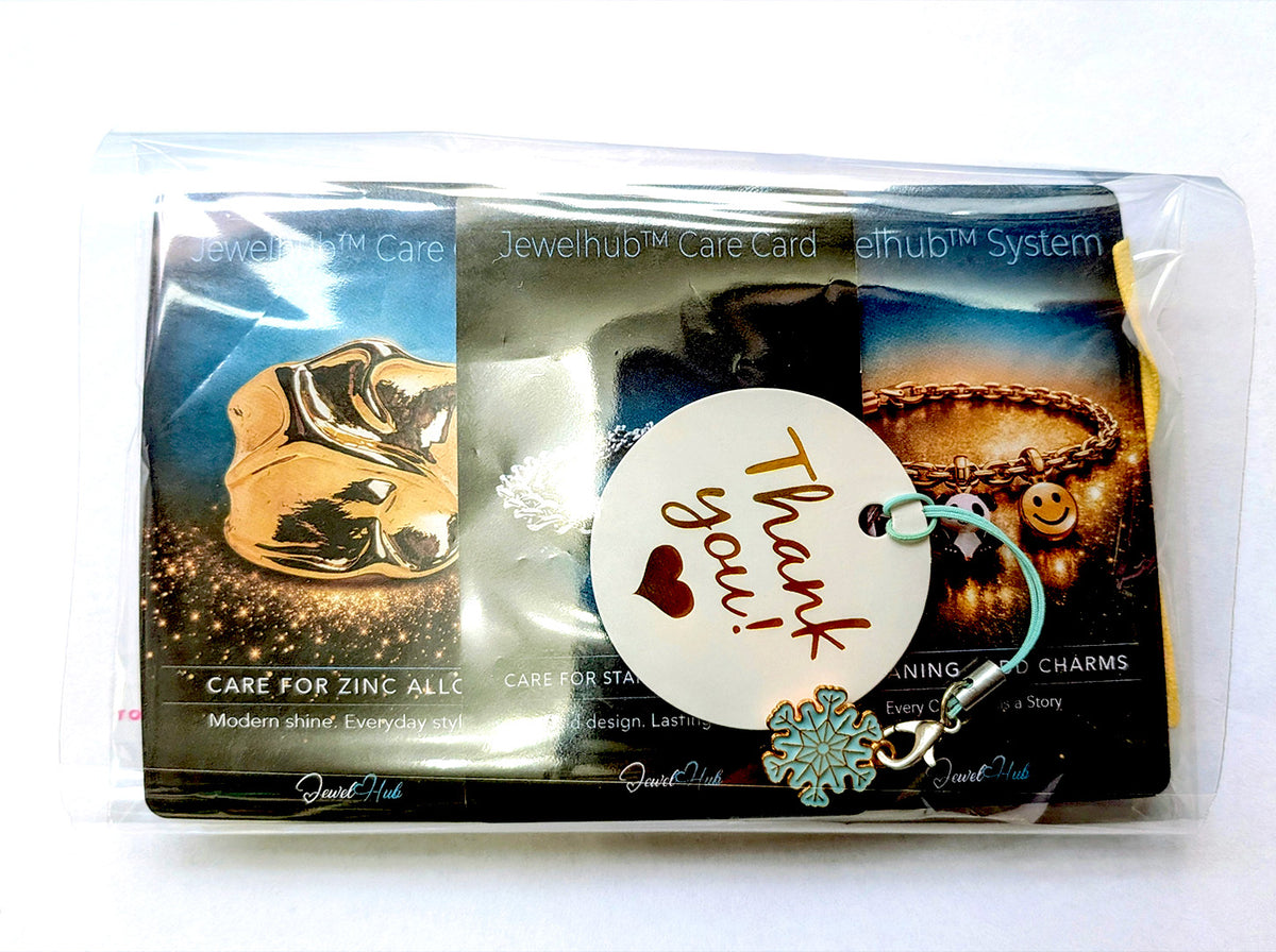 JewelHub Event Gift Bag in a clear zip bag with three material care cards and a Thank you tag with a snowflake charm