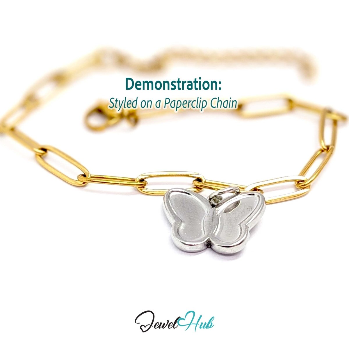 Silver butterfly charm styled on a gold paperclip chain for a two-tone mixed-metal look - JewelHub