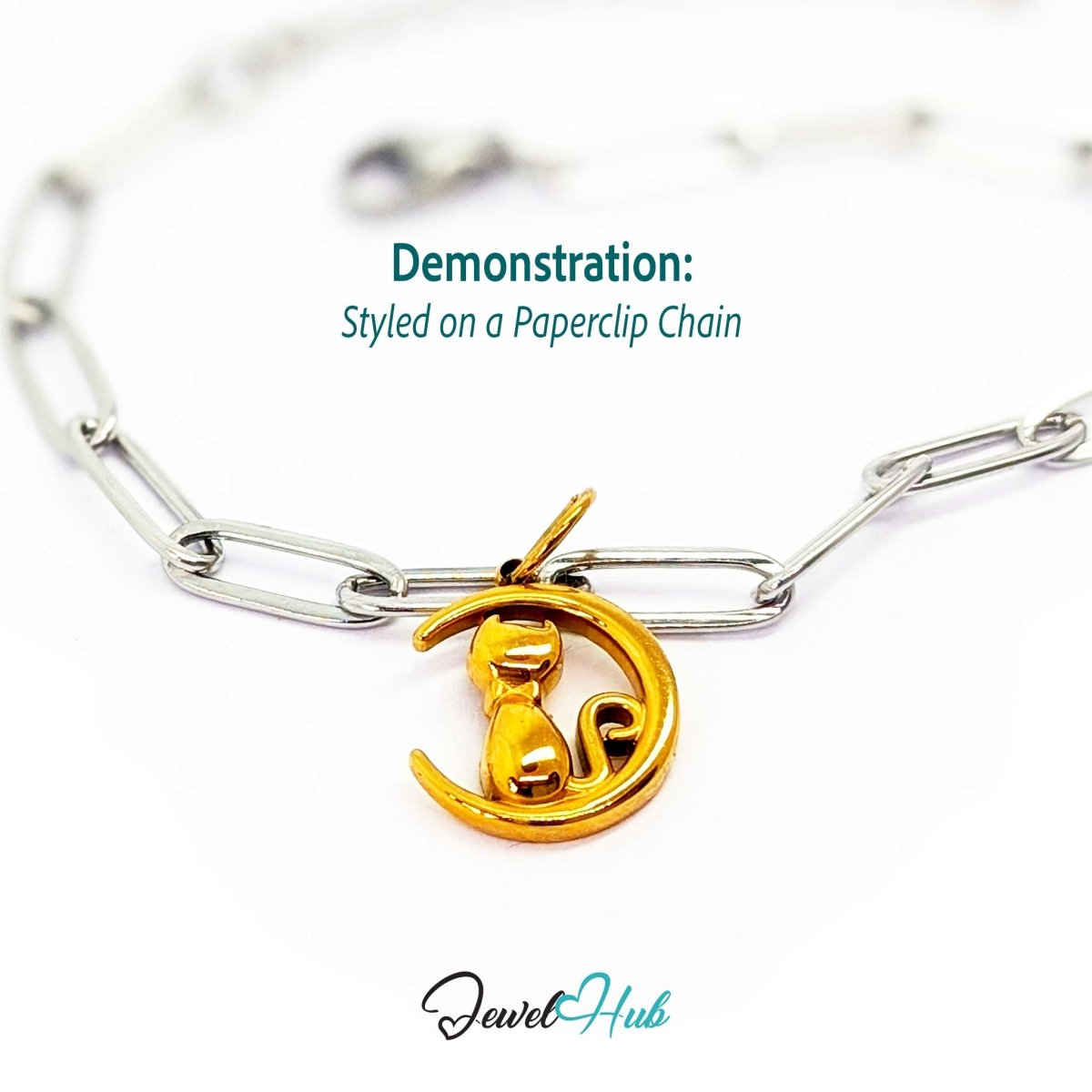Gold cat and moon charm styled on a silver paperclip chain bracelet for a two-tone look - JewelHub