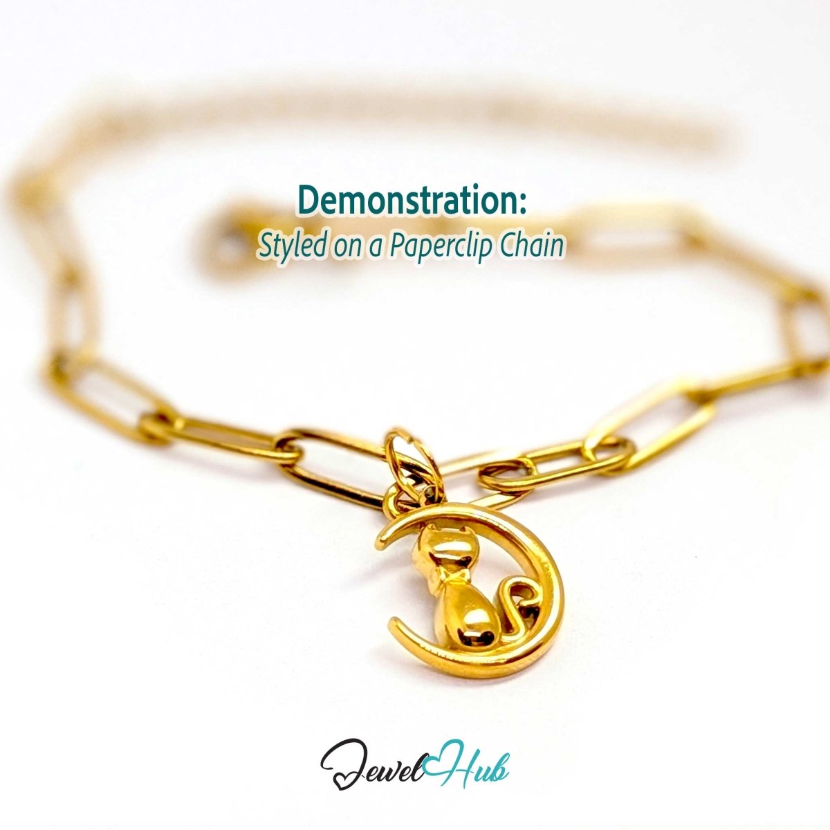 Gold cat and moon charm styled on a gold paperclip chain bracelet - JewelHub