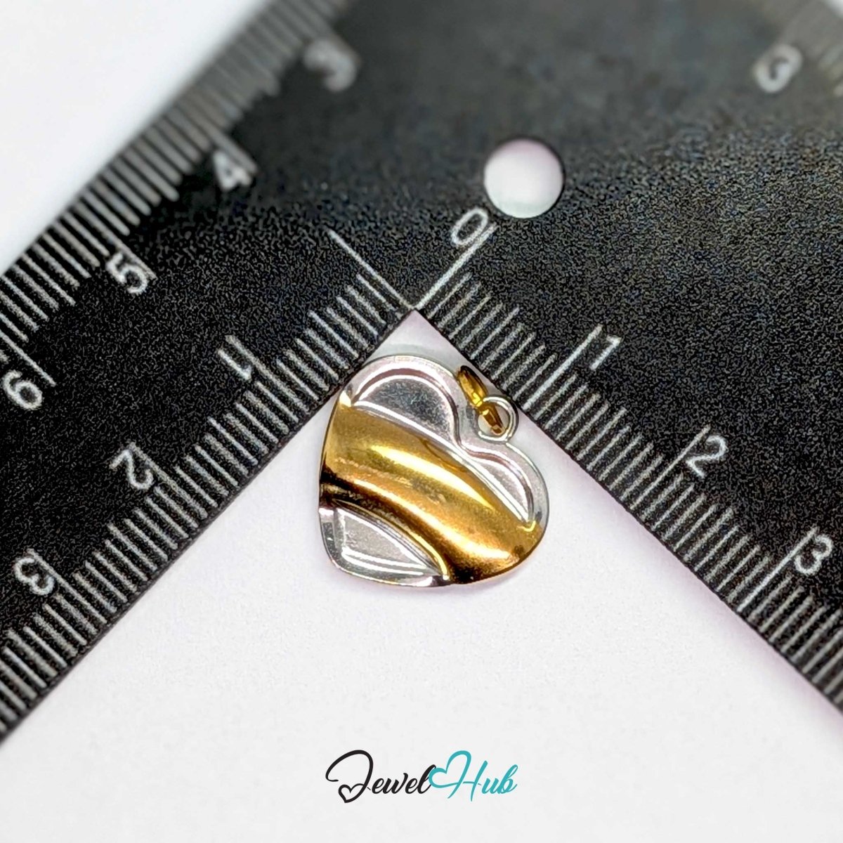 Curve Heart charm measured against a ruler at 17.3mm wide by 16.5mm tall - JewelHub
