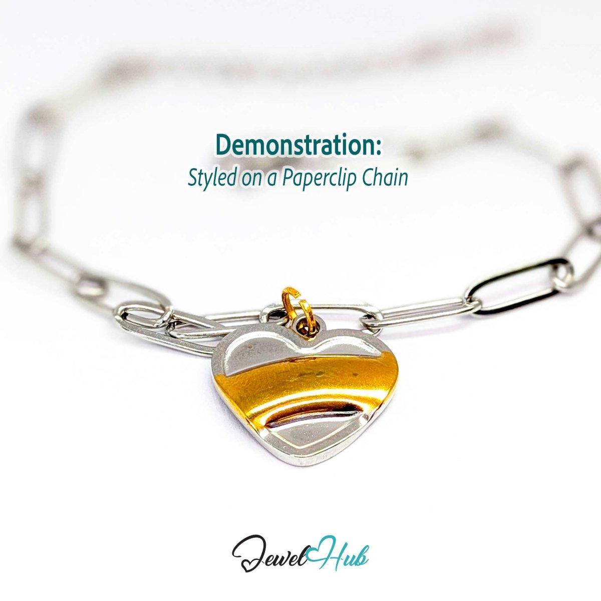 Two-tone Curve Heart charm styled on a silver paperclip chain bracelet - JewelHub