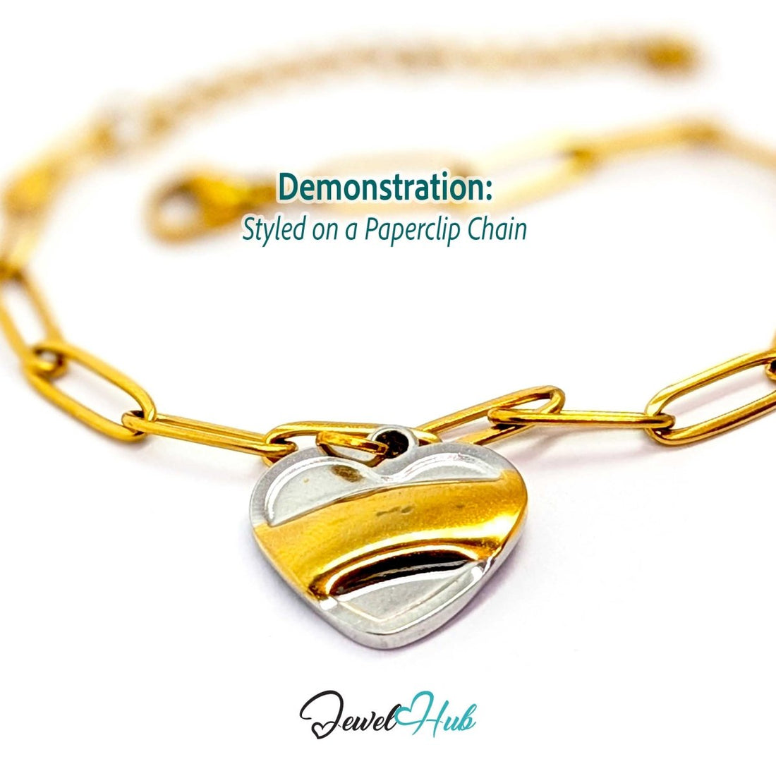 Two-tone Curve Heart charm styled on a gold paperclip chain bracelet - JewelHub