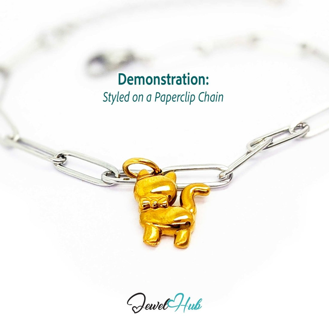 Gold cute cat charm styled on a silver paperclip chain bracelet for a two-tone look - JewelHub
