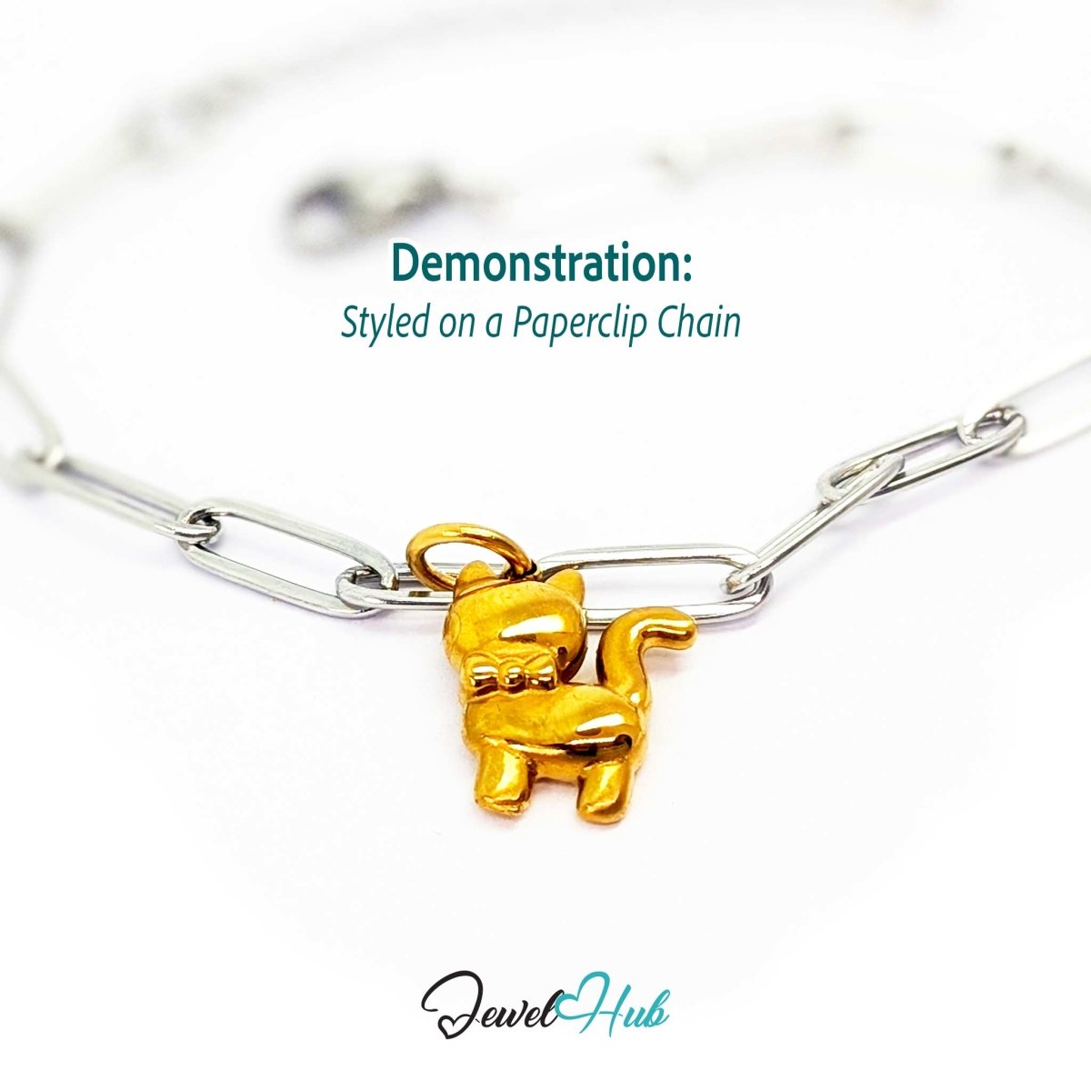 Gold cute cat charm styled on a silver paperclip chain bracelet for a two-tone look - JewelHub