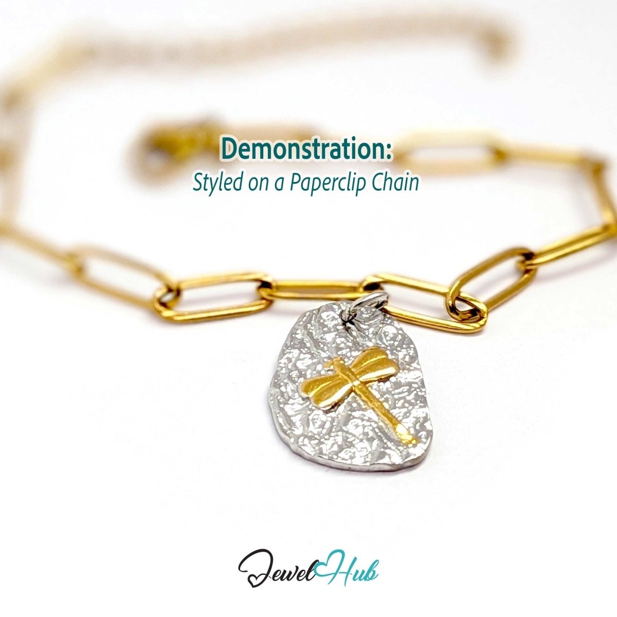 Two-tone dragonfly charm hanging from a gold paperclip chain bracelet - JewelHub