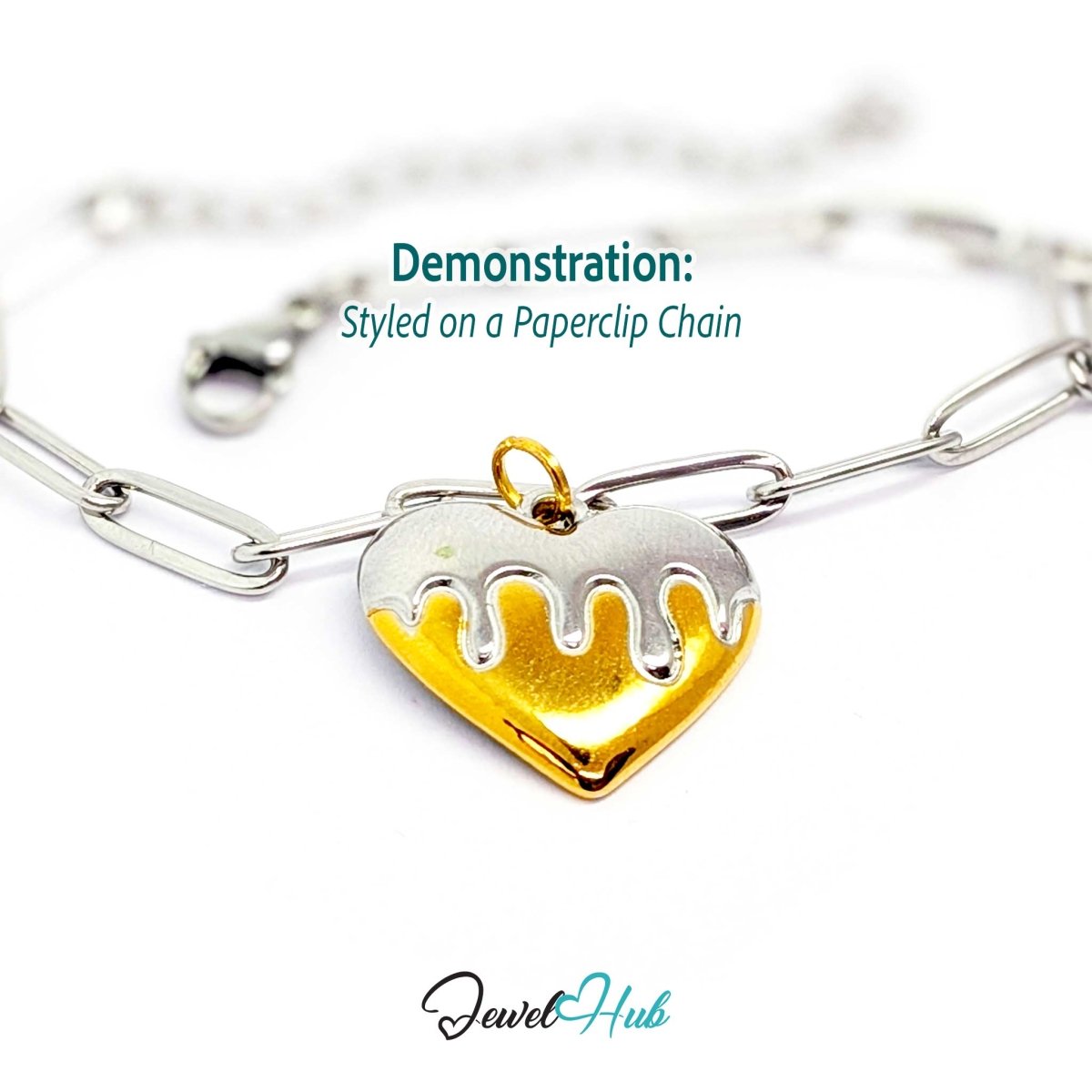 Drip Heart charm, two-tone stainless steel, styled on a silver paperclip chain bracelet - JewelHub