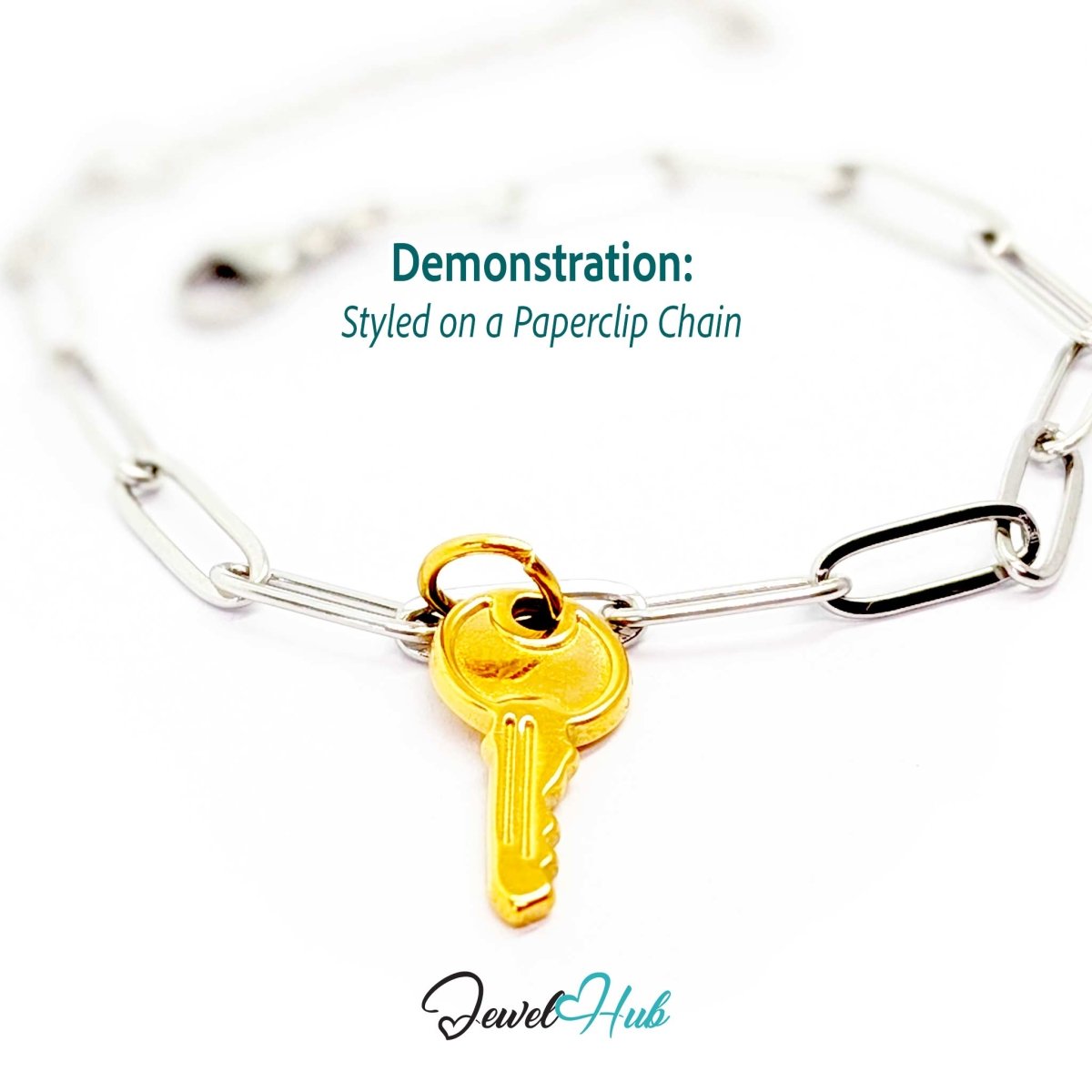 Everyday key charm in gold stainless steel with a plain round head - styled on a silver paperclip chain bracelet - JewelHub