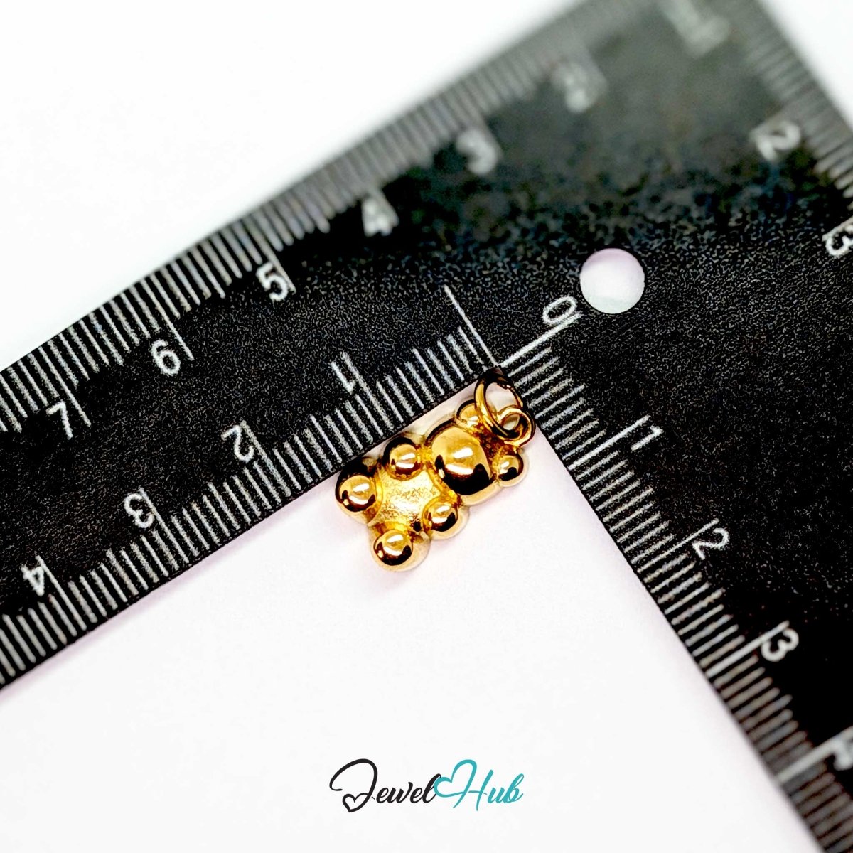 Gold Classic Gummy Bear charm measured against a ruler at 12mm wide by 17mm tall - JewelHub