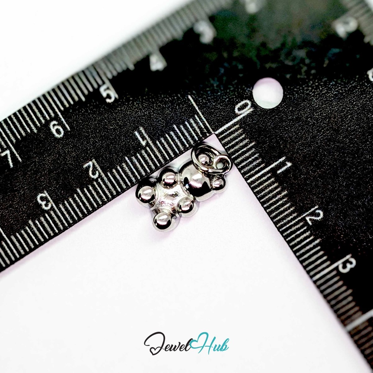 Silver Classic Gummy Bear charm measured against a ruler at 12mm wide by 17mm tall - JewelHub