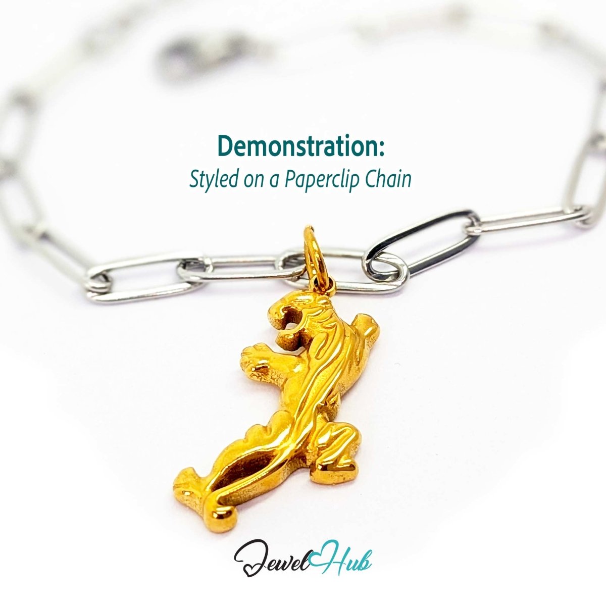Gold prowling tiger charm styled on a silver paperclip chain bracelet for a two-tone look - JewelHub