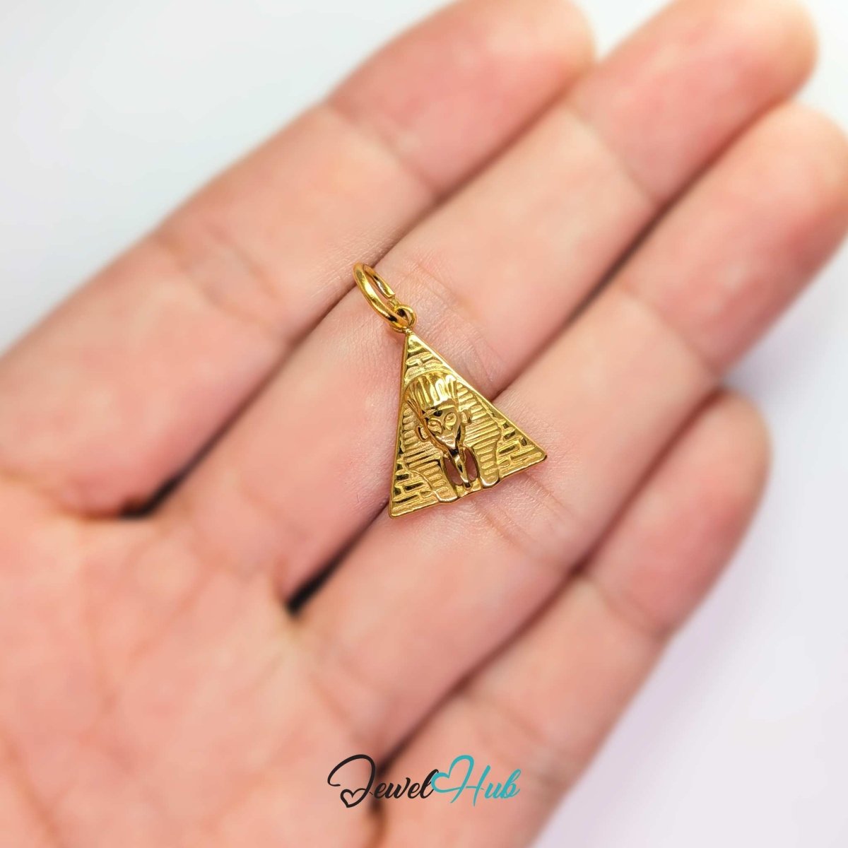 Pyramid and Sphinx charm in gold stainless steel - held in the hand for scale - JewelHub