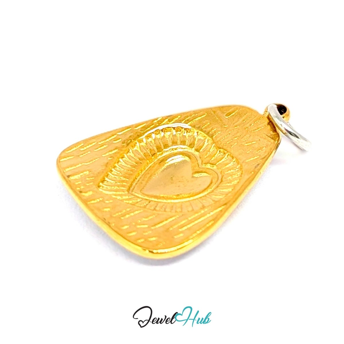 Radiant Heart charm turned to its gold reverse, the relief coming through the metal - JewelHub