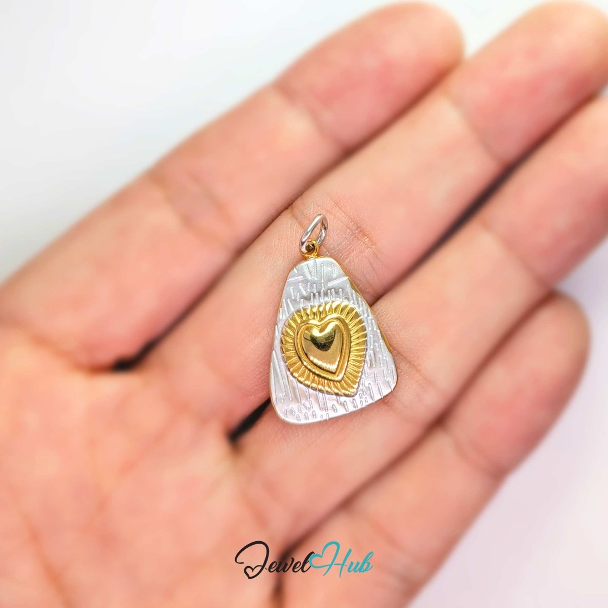 Two-tone Radiant Heart charm held in the hand to show its 21.5mm height - JewelHub