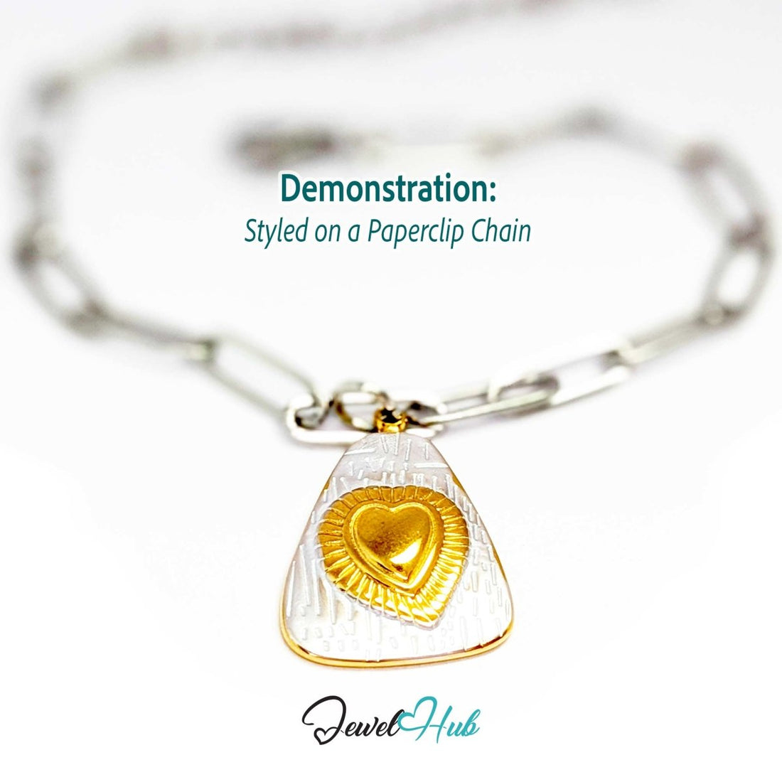 Two-tone Radiant Heart charm styled on a silver paperclip chain bracelet - JewelHub