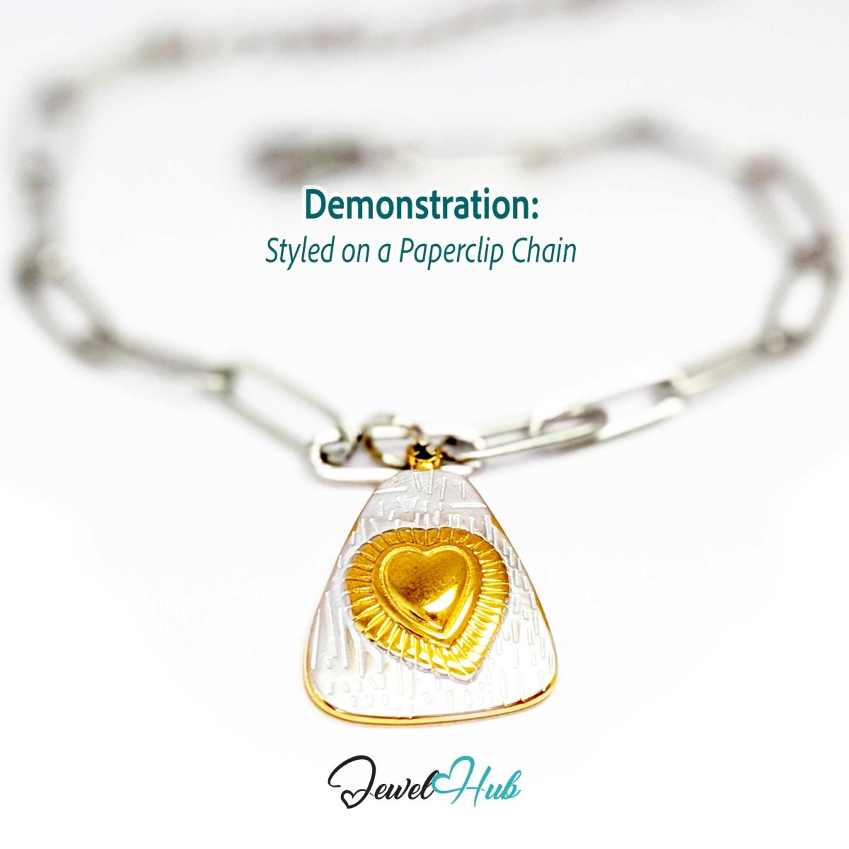 Two-tone Radiant Heart charm styled on a silver paperclip chain bracelet - JewelHub