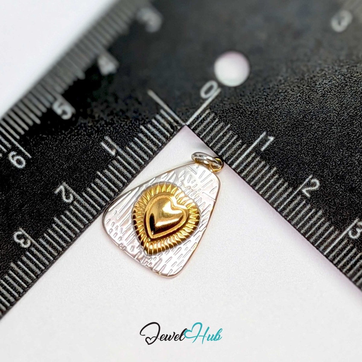 Radiant Heart charm measured against a ruler at 15.6mm wide by 21.5mm tall - JewelHub