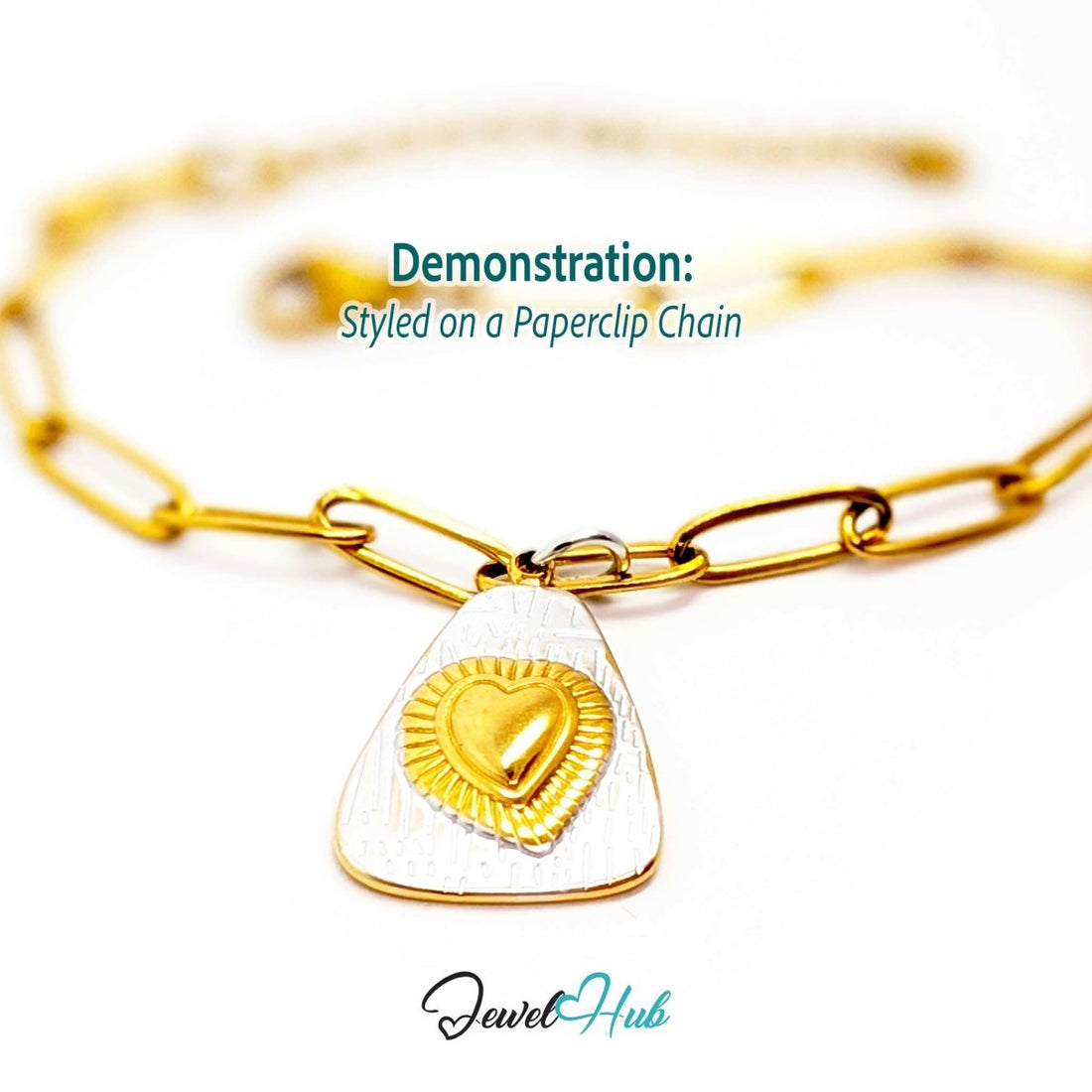 Two-tone Radiant Heart charm styled on a gold paperclip chain bracelet - JewelHub