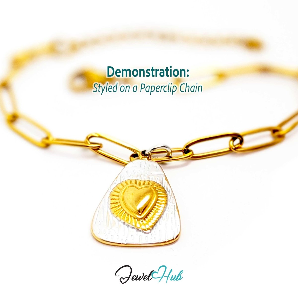 Two-tone Radiant Heart charm styled on a gold paperclip chain bracelet - JewelHub