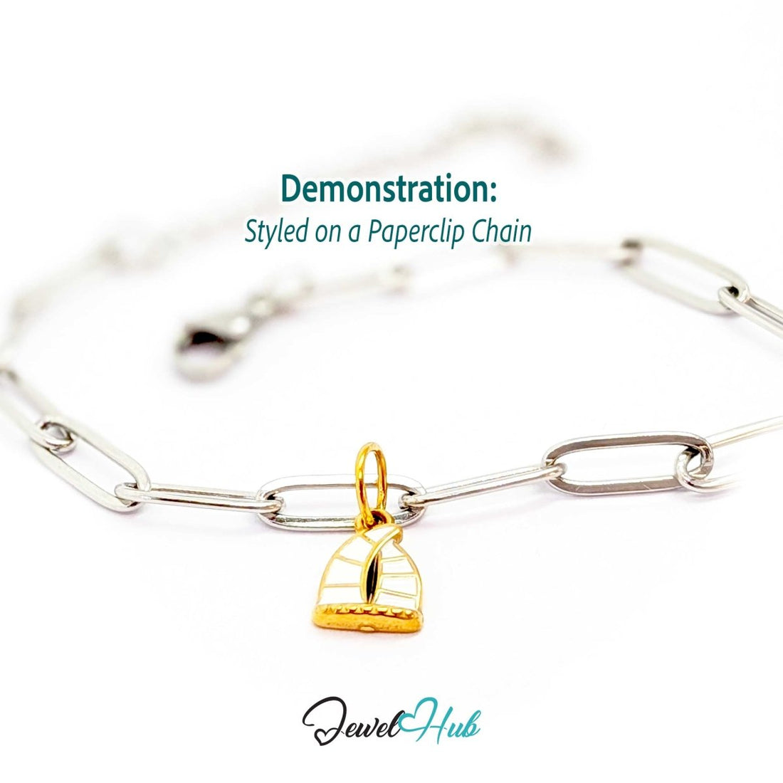 Sailboat charm in gold stainless steel with an openwork sail - styled on a silver paperclip chain bracelet - JewelHub