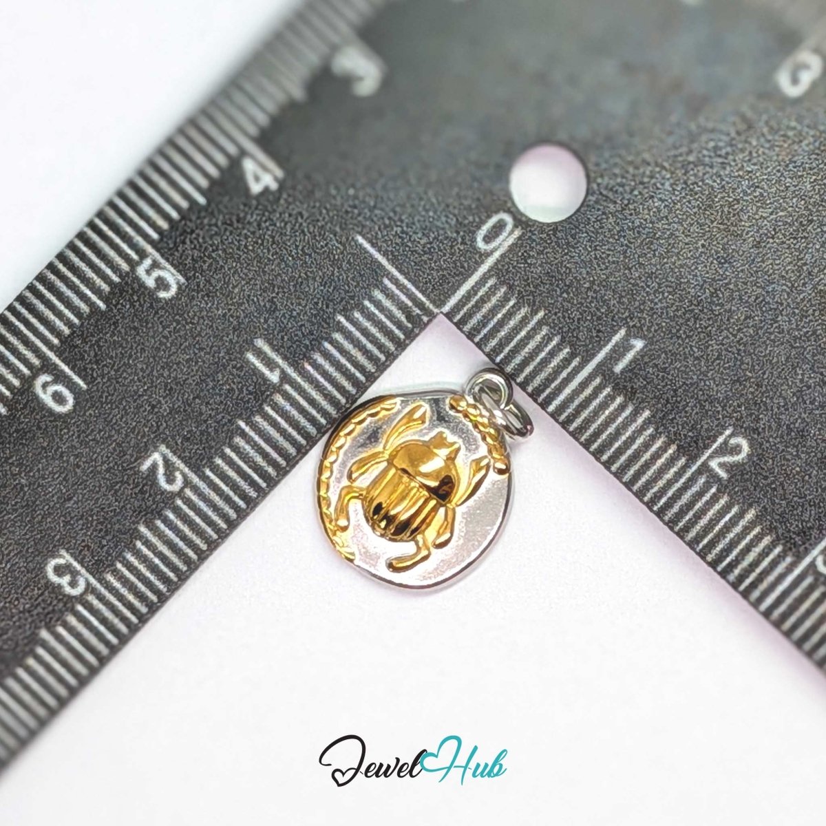 Scarab Oval charm, two-tone stainless steel, measured against a ruler at 13.7 x 17.2mm - JewelHub